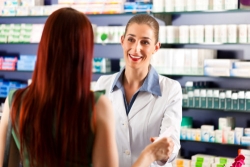 red haired customer talking with a pharmacist