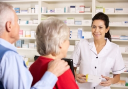 pharmacist serving elderly couple